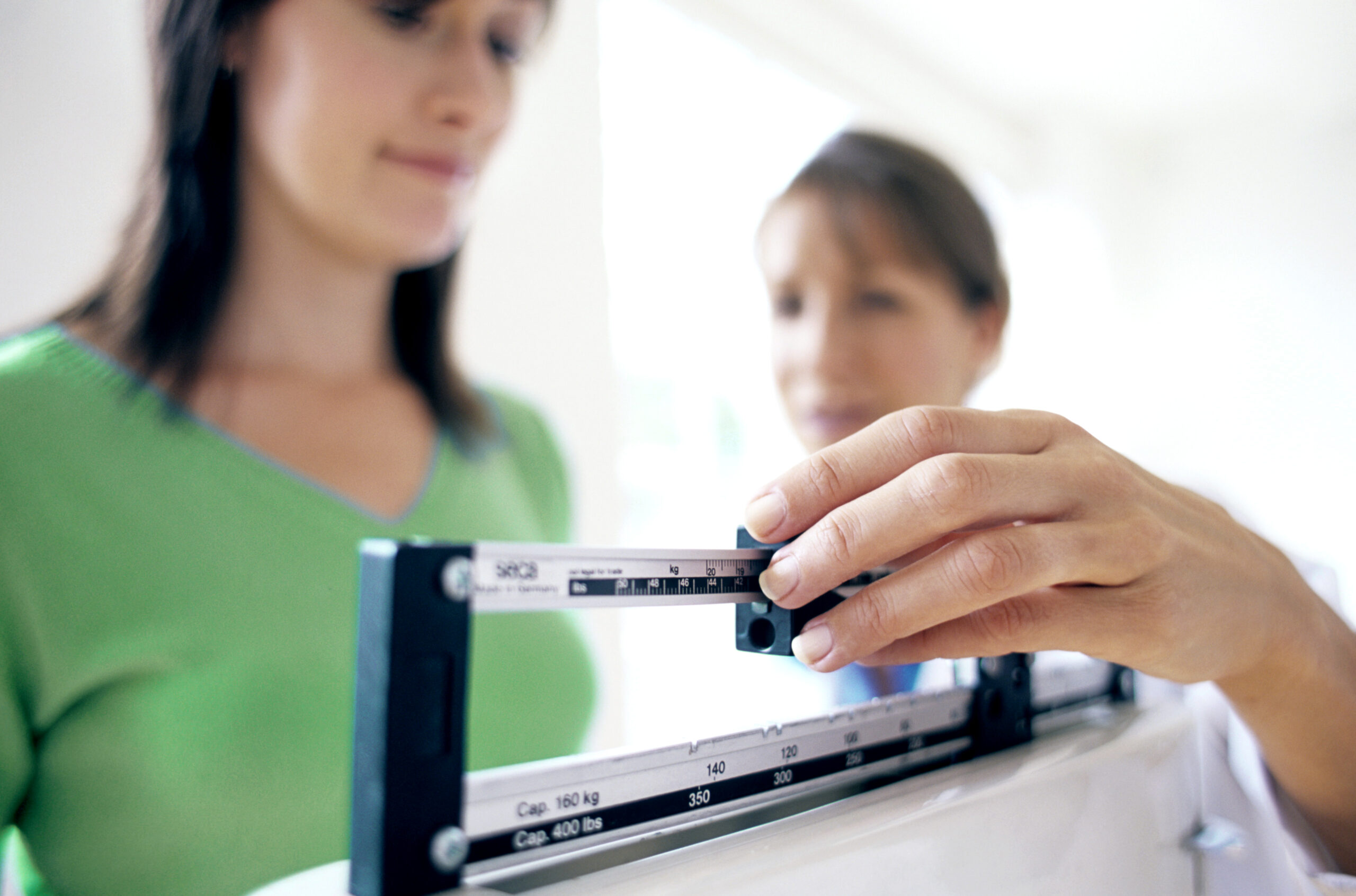 Woman using weight scale